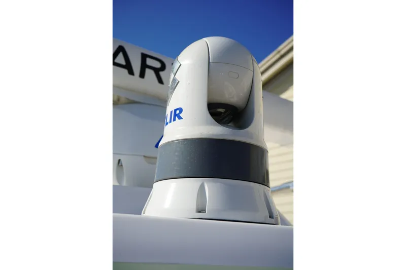 Slide: The Image of FLIR camera on 2024 Edgewater 285CC boat, clear blue sky background. - 39