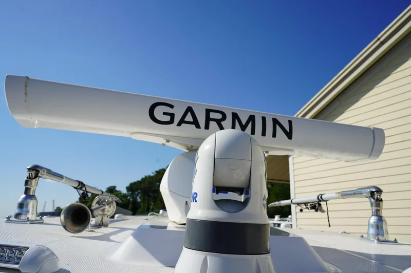Slide: The Image of Garmin radar on 2024 Edgewater 285CC boat under clear blue sky. - 41