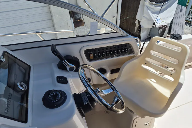 Slide: The Image of 2022 Grady-White Adventure 208 helm with steering wheel and control panel. - 10