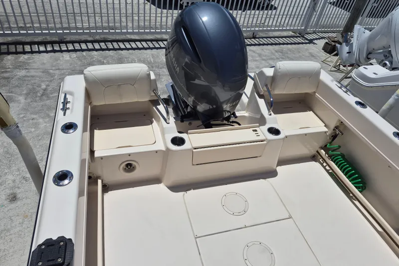 Slide: The Image of 2022 Grady-White Adventure 208 boat interior with motor and seating. - 14