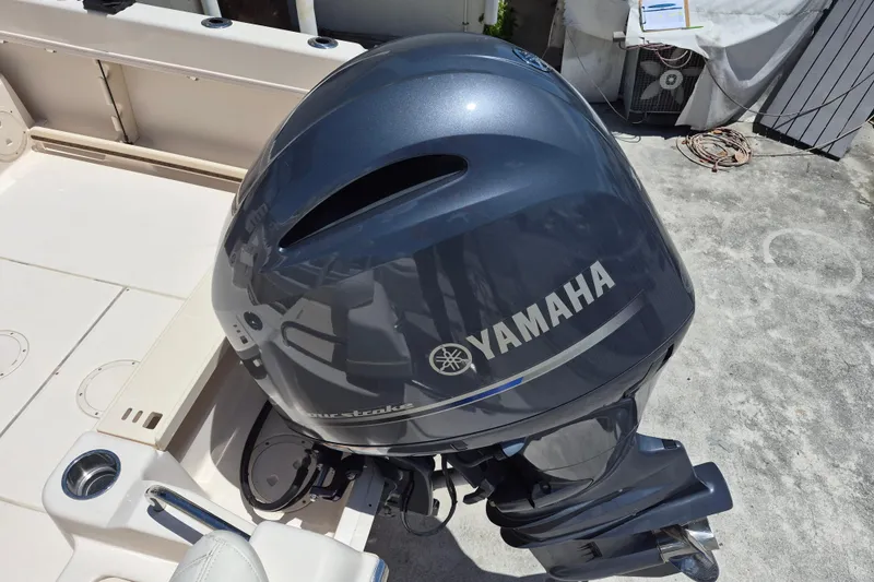 Slide: The Image of Yamaha outboard motor on 2022 Grady-White Adventure 208 boat, docked outdoors. - 15