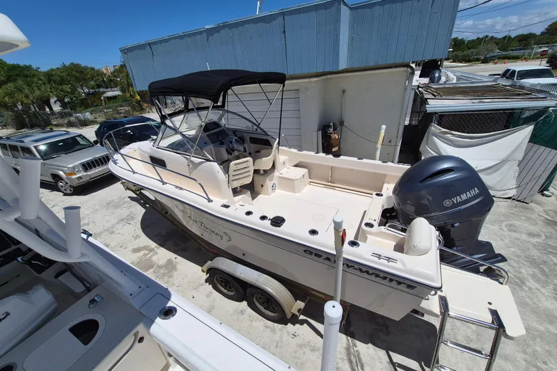 Slide: The Image of 2022 Grady-White Adventure 208 boat with Yamaha engine, parked outdoors. - 4