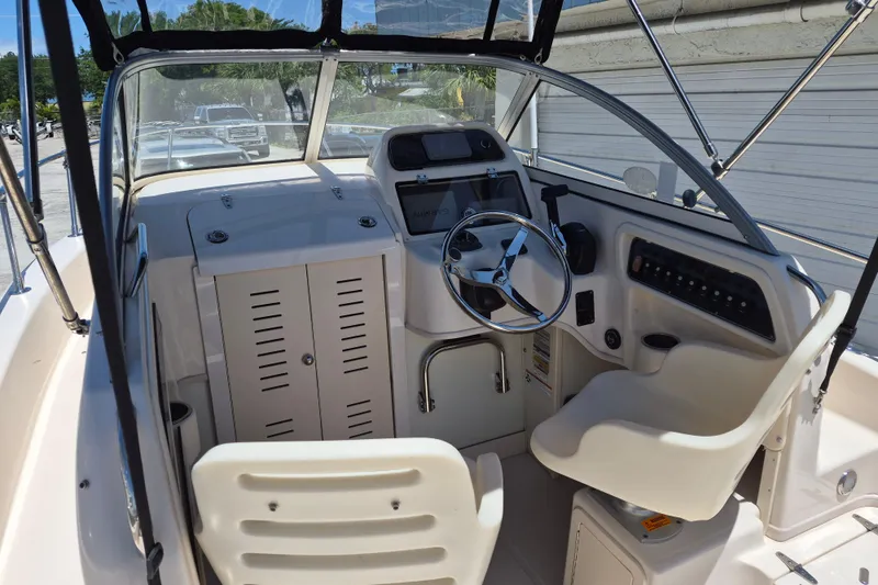 Slide: The Image of 2022 Grady-White Adventure 208 boat interior with steering wheel and control panel. - 6