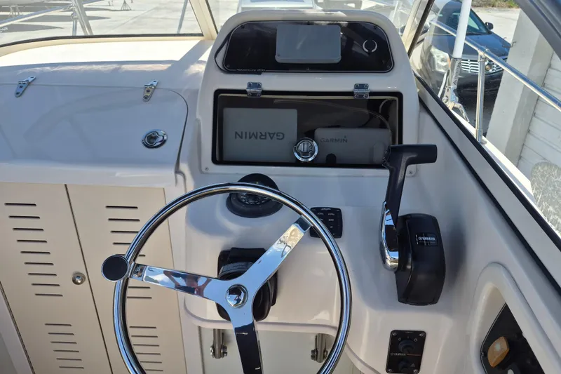Slide: The Image of 2022 Grady-White Adventure 208 boat helm with Garmin navigation and Yamaha controls. - 7