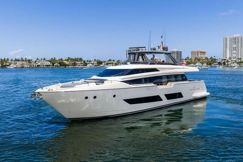 The Image of 2018 Ferretti Yachts 850 Motoryacht cruising on a sunny day near luxury waterfront homes. - 0