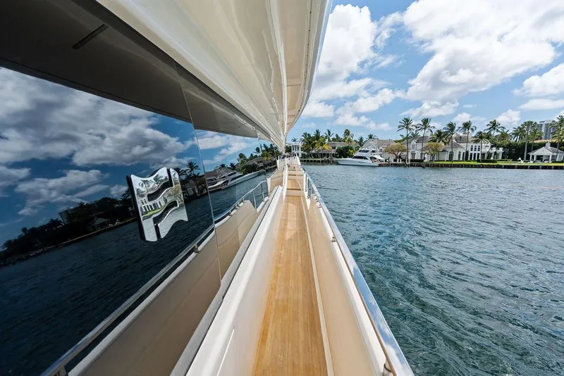 Slide: The Image of 2018 Ferretti Yachts 850 Motoryacht cruising along a scenic waterfront. - 10
