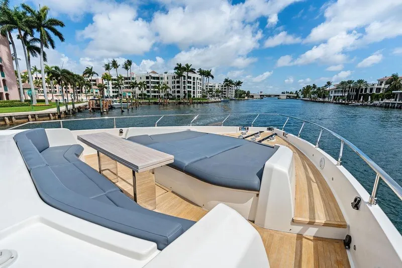 Slide: The Image of Luxurious 2018 Ferretti Yachts 850 Motoryacht deck with seating, overlooking scenic waterfront. - 11