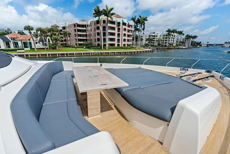 Slide: The Image of Luxurious seating area on 2018 Ferretti Yachts 850 Motoryacht, overlooking waterfront and palm trees. - 12
