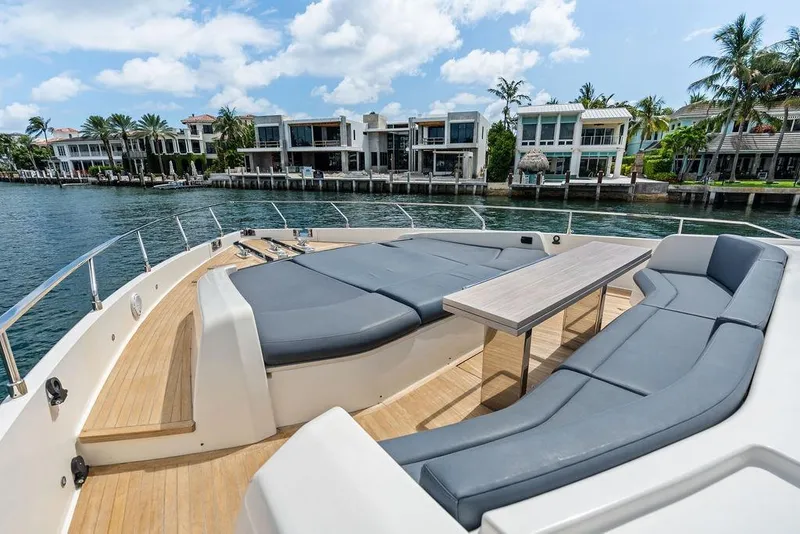 Slide: The Image of Luxurious 2018 Ferretti Yachts 850 Motoryacht deck with seating, table, and waterfront view. - 13