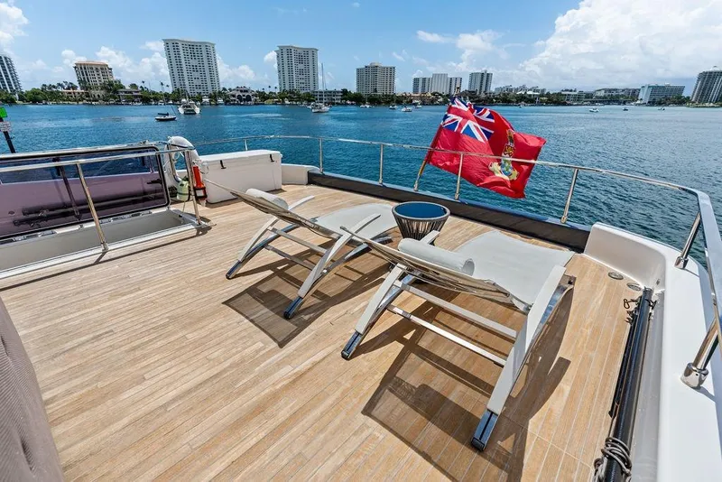 Slide: The Image of Luxurious 2018 Ferretti Yachts 850 Motoryacht deck with sun loungers and ocean view. - 16