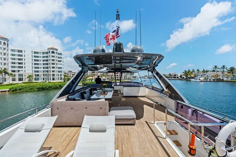 Slide: The Image of Luxurious 2018 Ferretti Yachts 850 Motoryacht on scenic waterfront, featuring elegant deck seating. - 18