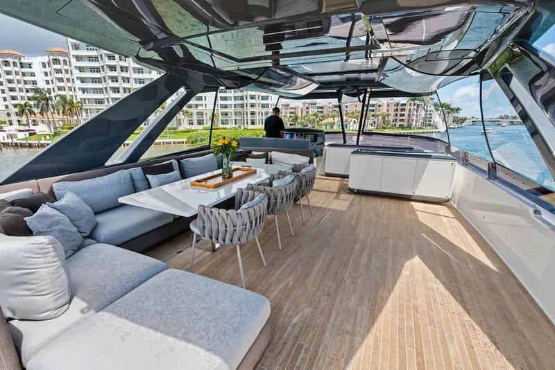 Slide: The Image of Luxurious 2018 Ferretti Yachts 850 Motoryacht with elegant outdoor seating and scenic waterfront views. - 19