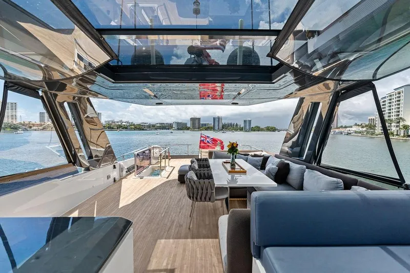 Slide: The Image of Luxurious 2018 Ferretti Yachts 850 Motoryacht interior with elegant seating and scenic water views. - 24