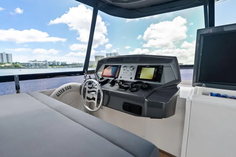 Slide: The Image of 2018 Ferretti Yachts 850 Motoryacht helm with modern navigation equipment and scenic water view. - 27