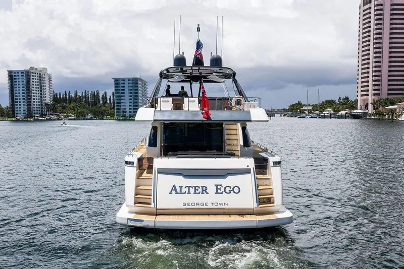 Slide: The Image of 2018 Ferretti Yachts 850 Motoryacht cruising in a city waterway, rear view. - 3