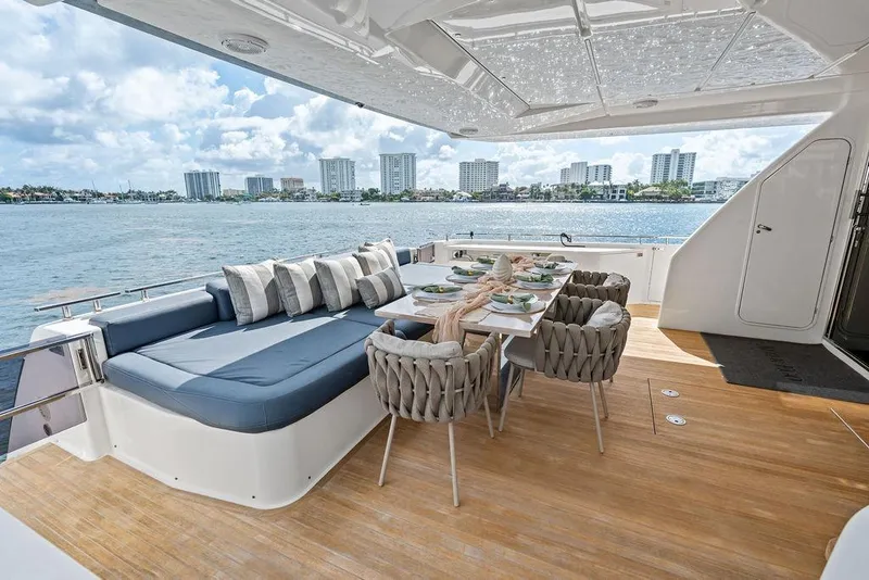 Slide: The Image of Luxurious 2018 Ferretti Yachts 850 Motoryacht deck with elegant dining setup and waterfront view. - 33