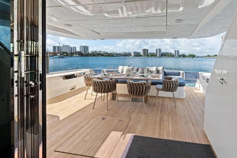 Slide: The Image of Luxurious 2018 Ferretti Yachts 850 Motoryacht deck with elegant dining area and scenic waterfront view. - 37