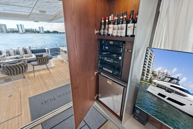 Slide: The Image of Luxurious 2018 Ferretti Yachts 850 Motoryacht interior with wine cabinet and scenic water view. - 39