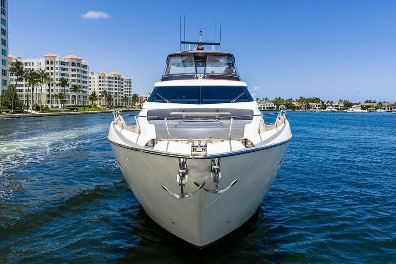 Slide: The Image of 2018 Ferretti Yachts 850 Motoryacht cruising near waterfront buildings under clear blue sky. - 4