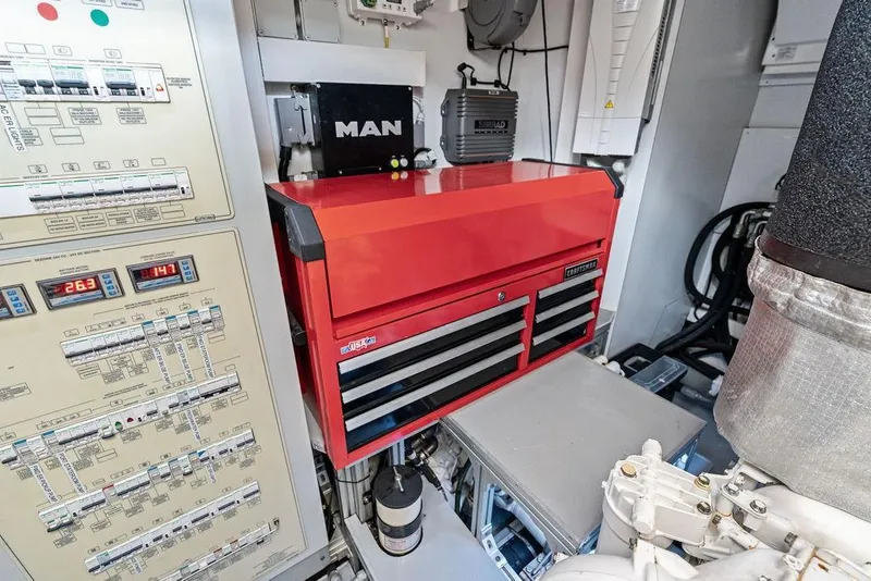 Slide: The Image of Engine room of 2018 Ferretti Yachts 850 Motoryacht with control panel and red toolbox. - 83