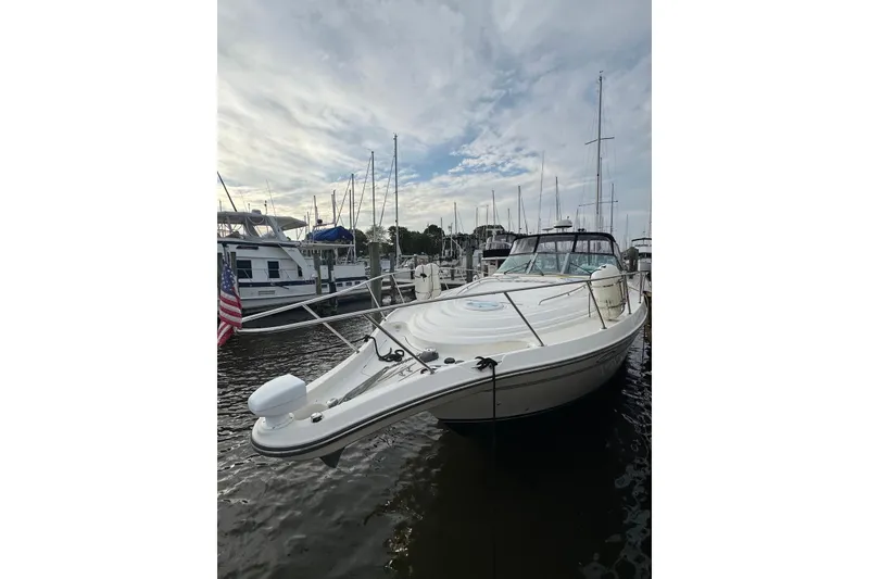 The Image of 1998 Maxum 4100 SCR yacht docked at marina under cloudy sky. - 0