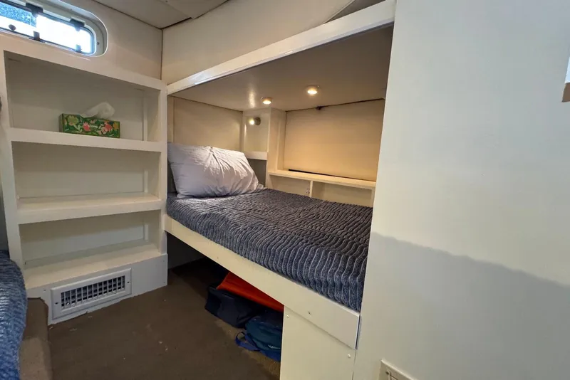 Slide: The Image of Cozy cabin interior of 1998 Maxum 4100 SCR with bed and shelving. - 13