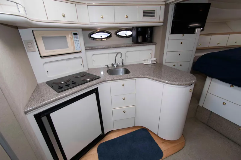 Slide: The Image of 1998 Maxum 4100 SCR yacht interior kitchen with modern appliances and sleek cabinetry. - 14
