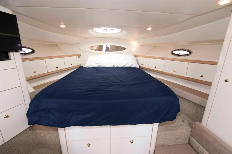 Slide: The Image of Luxurious cabin interior of 1998 Maxum 4100 SCR yacht with cozy bed and elegant design. - 15