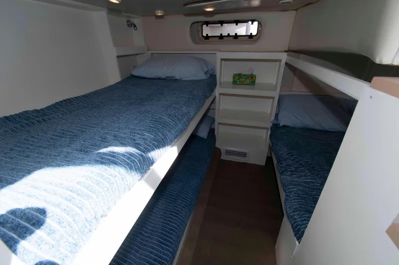 Slide: The Image of Interior cabin of 1998 Maxum 4100 SCR yacht with bunk beds and blue bedding. - 17