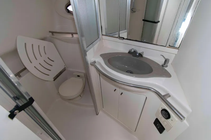 Slide: The Image of Bathroom interior of 1998 Maxum 4100 SCR yacht with sink and toilet. - 19