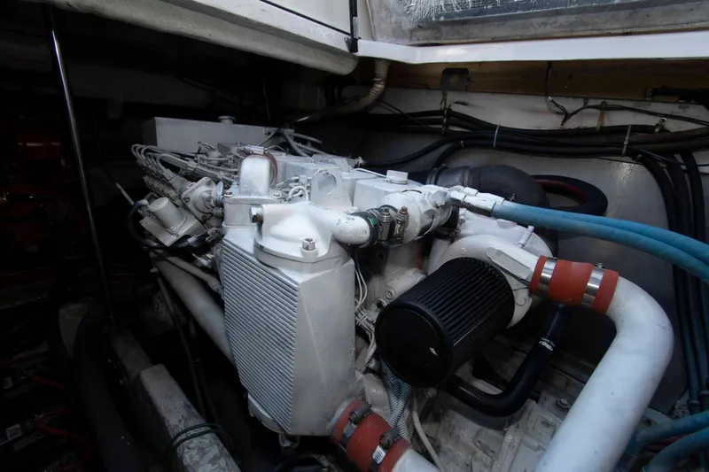 Slide: The Image of Engine compartment of a 1998 Maxum 4100 SCR boat, showcasing mechanical components and hoses. - 21