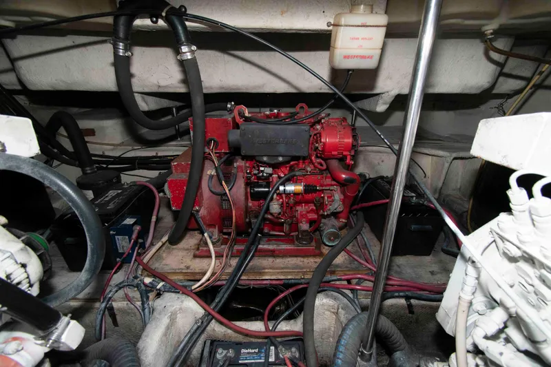 Slide: The Image of Engine compartment of a 1998 Maxum 4100 SCR boat, featuring a red engine. - 23