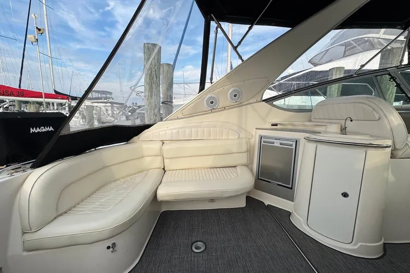 Slide: The Image of Luxurious interior of 1998 Maxum 4100 SCR yacht with cream seating and kitchenette. - 3