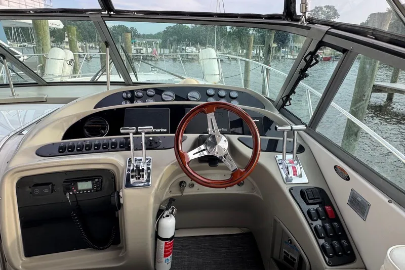 Slide: The Image of Cockpit view of 1998 Maxum 4100 SCR yacht with steering wheel and controls. - 6
