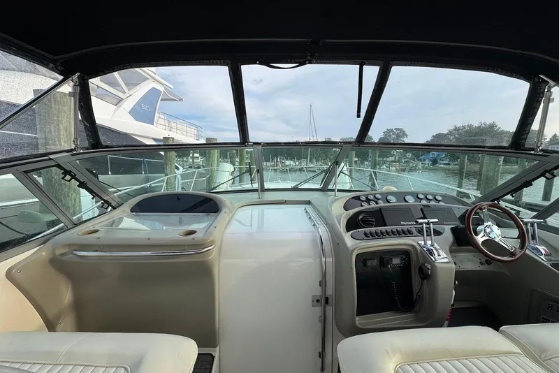 Slide: The Image of Cockpit view of a 1998 Maxum 4100 SCR yacht at a marina. - 7