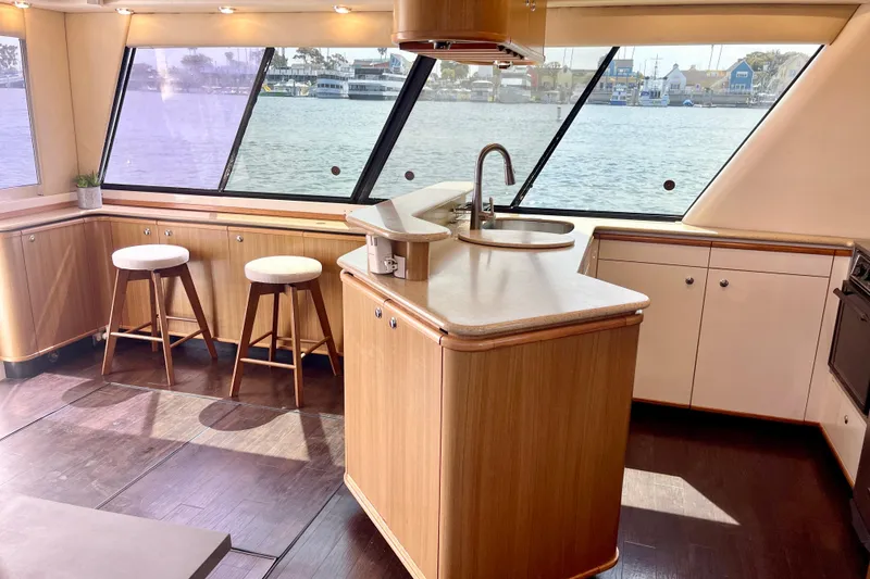 Slide: The Image of Luxurious 2001 Bayliner 4788 Pilot House Motoryacht interior with modern kitchen and waterfront view. - 10