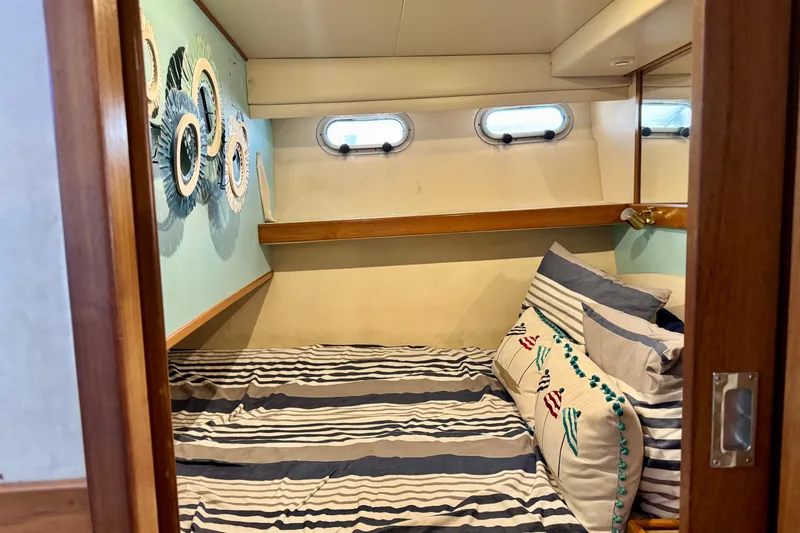 Slide: The Image of Cozy cabin interior of 2001 Bayliner 4788 Pilot House Motoryacht with nautical decor. - 13