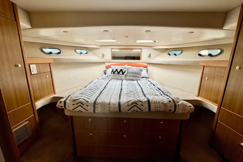 Slide: The Image of Luxurious bedroom interior of 2001 Bayliner 4788 Pilot House Motoryacht with stylish bedding. - 14