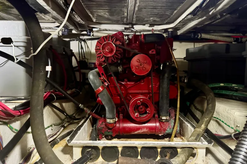 Slide: The Image of Engine room of 2001 Bayliner 4788 Pilot House Motoryacht with red machinery and cables. - 16