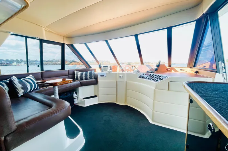 Slide: The Image of Interior of 2001 Bayliner 4788 Pilot House Motoryacht with panoramic windows and plush seating. - 7