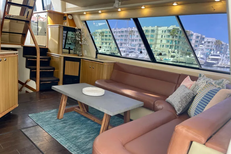 Slide: The Image of Luxurious interior of 2001 Bayliner 4788 Pilot House Motoryacht with leather seating and large windows. - 8
