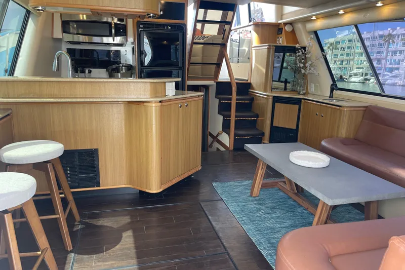 Slide: The Image of Interior of 2001 Bayliner 4788 Pilot House Motoryacht with modern kitchen and seating area. - 9
