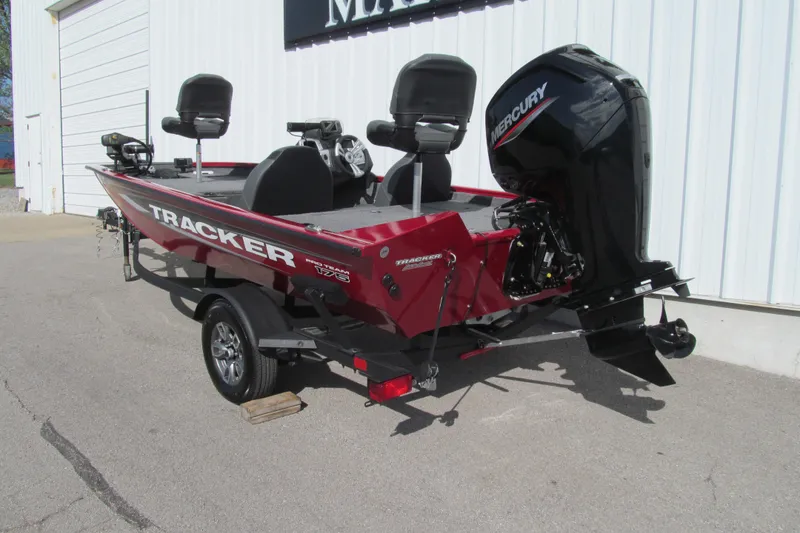 Slide: The Image of 2025 Tracker Pro Team 175 boat with Mercury engine, parked outside a building. - 3