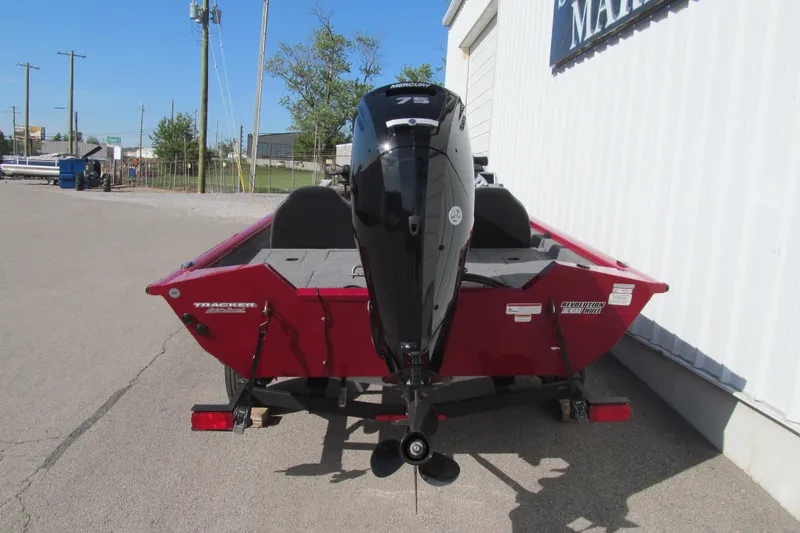Slide: The Image of 2025 Tracker Pro Team 175 boat with Mercury outboard motor, parked outdoors. - 4