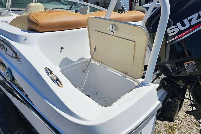 Slide: The Image of 2019 Caravelle 17 EBo Bowrider boat with open storage compartment and Suzuki engine. - 10