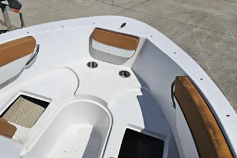 Slide: The Image of 2019 Caravelle 17 EBo Bowrider boat interior with brown seating and cup holders. - 11