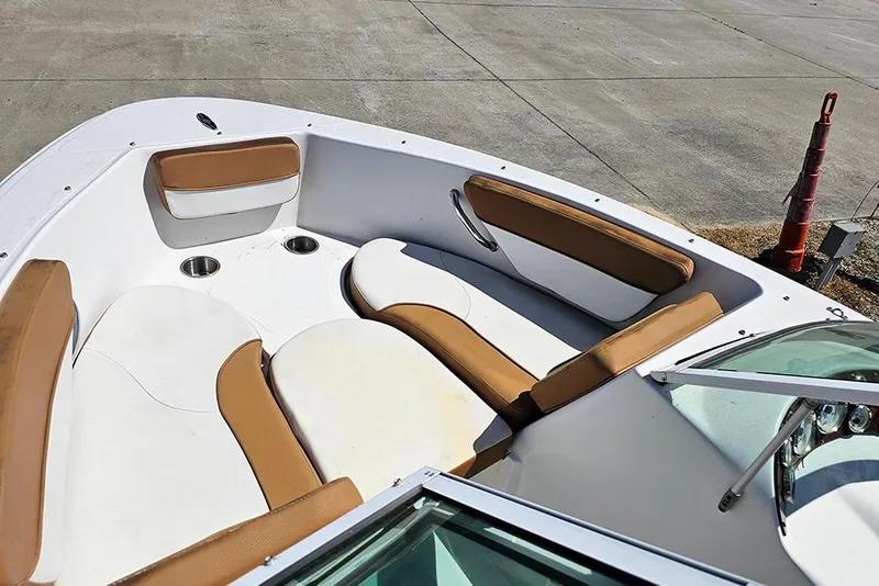 Slide: The Image of 2019 Caravelle 17 EBo Bowrider boat interior with tan and white seating. - 12