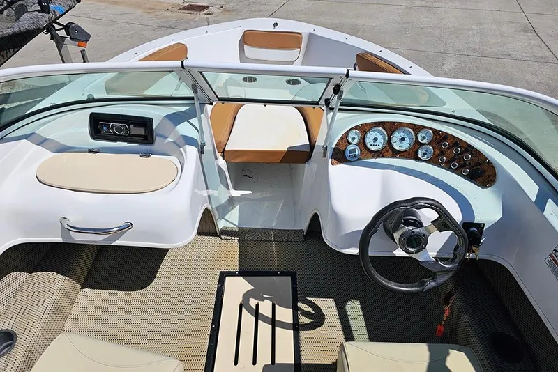 Slide: The Image of 2019 Caravelle 17 EBo Bowrider interior with steering wheel, dashboard, and seating. - 14