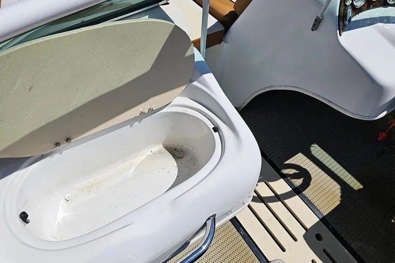 Slide: The Image of Open storage compartment on 2019 Caravelle 17 EBo Bowrider boat interior. - 16