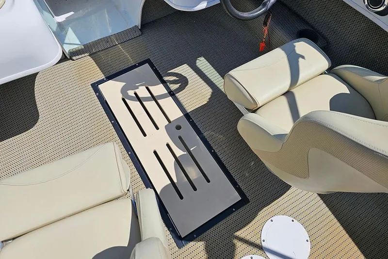 Slide: The Image of Interior of 2019 Caravelle 17 EBo Bowrider with beige seating and textured flooring. - 17
